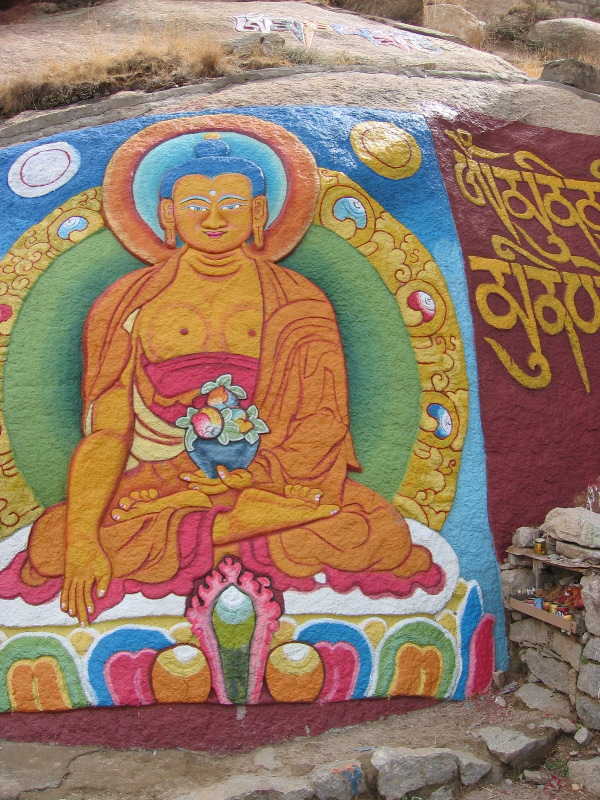 Buddha_painted_on_a_rock_wall_in_Tibet.jpg